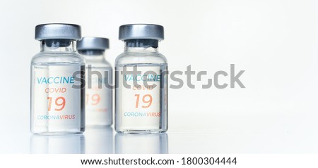 Closeup transparent vials with new vaccine for covid-19 coronavirus, flu, infectious diseases. Injection after clinical trials for vaccination of human, child, adult, senior. Medicine, drug concept.