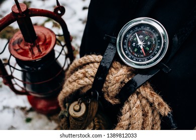 Close-up Travel Accessories Survival Kit Tools. Compass, Backpack, Gas Lamp Background. Winter Travel Stuff 