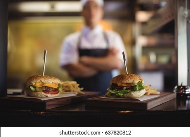 Close-up of tray with french fries and burger at order station in the commercial kitchen - Powered by Shutterstock