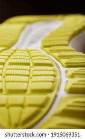 Close-up Of The Tread Of A Yellow Sneaker, The Textured Pattern Of The Sole. Macro