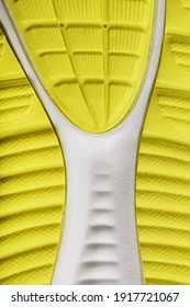 Close-up Of The Tread Of A Yellow Sneaker, The Textured Pattern Of The Sole. Macro