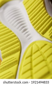 Close-up Of The Tread Of A Yellow Sneaker, The Textured Pattern Of The Sole. Macro