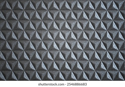 O close de uma textura triangular revela linhas agudas e precisão geométrica. Cada ângulo e aresta cria um padrão arrojado e impressionante, desenhando o olho no design intrincado que parece dinâmico.