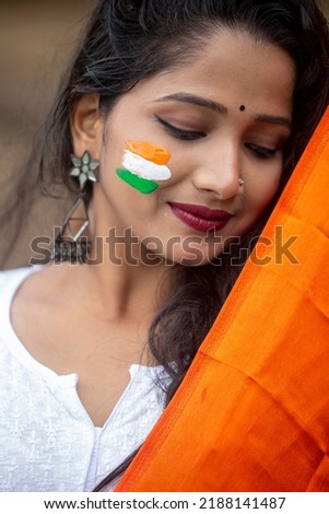 Closeup of Tricolor Indian flag Painted on happy smiling young girls during Indian Independence or republic day celebration - concept of patriotism or support for country.