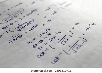 closeup of trigonometry mathematics book equations handwritten on white paper - Powered by Shutterstock