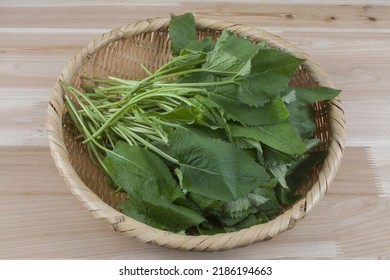 Close-up Of Trimmed Raw Chwinamul(woodwind Reed) On Bamboo Basket And Wooden Floor, South Korea 
