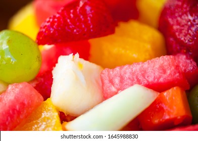 Close-up Of Tropical Fruit Salad Featuring Brightly Colored Watermelon, Pineapple, Grape, Cantaloupe, Strawberry, And Orange Slices