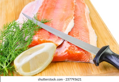 Closeup For Trout Fish Fillet With Knife On A Kitchen Board