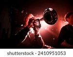 Close-up of a trumpet player during a live funky rock concert.