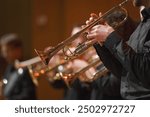 Close-up of a trumpet player performing in a brass ensemble, focusing on the musician