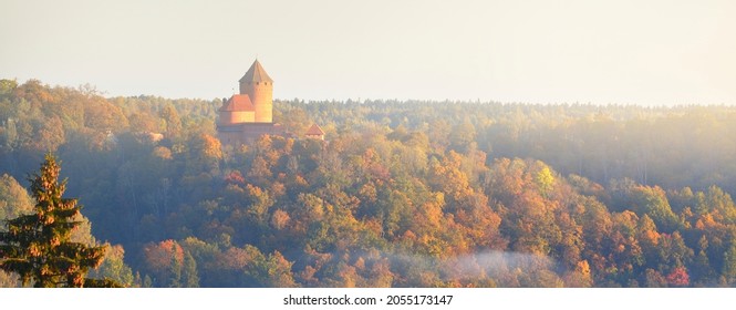 Close-up Of The Turaida Castle Tower And Golden Forest In A Clouds Of Morning Fog At Sunrise. Travel Guide, Sightseeing Theme. Gauja National Park, Latvia