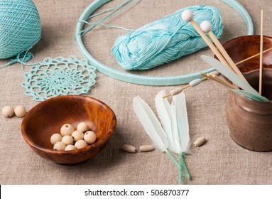 Close-up Of Turquoise Yarn And Dream Catcher To Be Assembled. Handmade Workshop Composition Of Feathers, Beads, Tools For DIY  