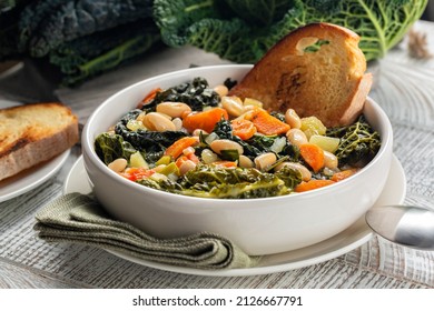 Close-up of Tuscan vegetarian bread Soup made with toasted bread and vegetables. Ribollita. Cannellini beans, lacinato kale, cabbage verza, carrot, celery, potatoes, and onion. Itralian food. 