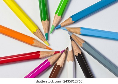 Close-up of twelve colour pencils radially pointing towards each other with their tips and forming a circle - Powered by Shutterstock