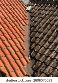 Close-up of two adjoining clay tile roofs with different colors and weathering, creating a unique architectural texture.