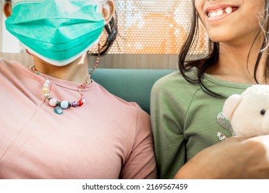 Closeup of two Asian teen girls hangout together with only one of them wearing face mask	