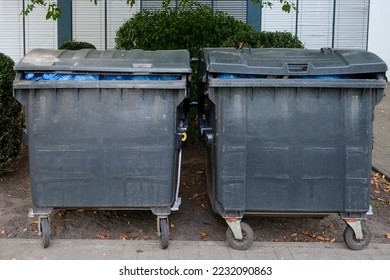 Close-up of two bins filled to the brim with blue bin bags - selective focus - Shutterstock ID 2232090863