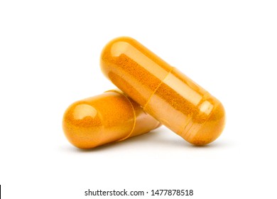 Close-up Two capsules of Finely ground dry Turmeric (Curcuma longa Linn) isolated on white background.  - Shutterstock ID 1477878518