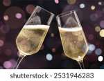 Close-up of two champagne glasses clinking, filled with bubbly champagne. Celebration with champagne, sparkling bubbles, and festive atmosphere. Cheers with champagne!