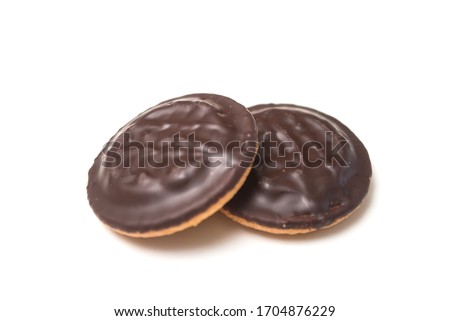 Closeup of two chocolate cakes with jam on white background