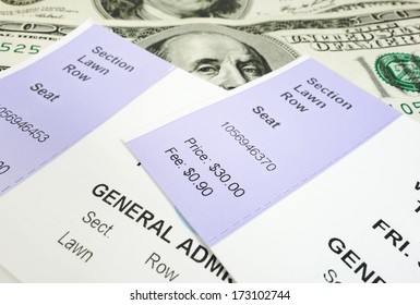 Closeup Of Two Concert Tickets And Cash                               