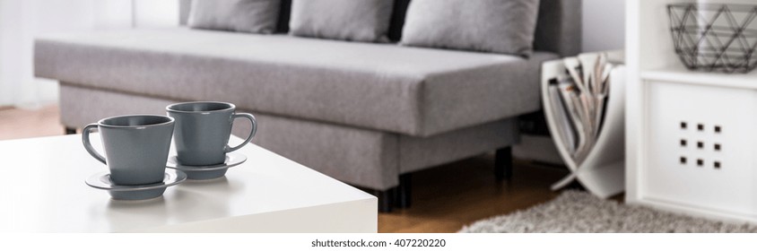 Close-up of two cup with hot tea on coffee table in modern living room