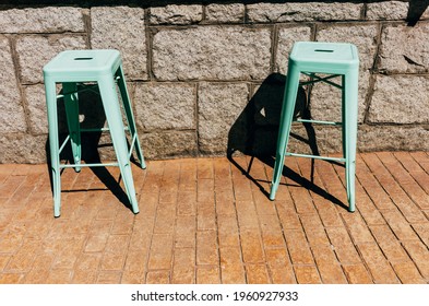 A Closeup Of Two Free Plastic Stools At The Outdoor Bar