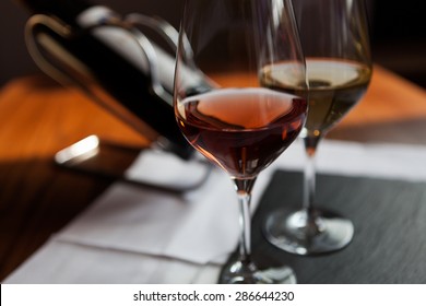 Closeup Of Two Glasses And Bottle Of Wine On The Table