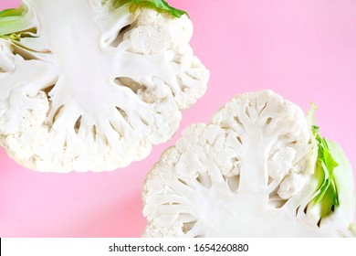 Close-up two half head fresh organic cauliflower on a bright pink background. Minimalistic, natural, lifestyle. Diet concept, healthy food.Top view, flat lay, copy space for text. - Shutterstock ID 1654260880