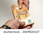 Close-up of two hands of people exchange a 50 euro notes to buy and sell. High quality photo