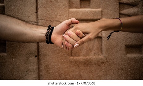 Close-up Of Two Hands Pulling Each Other