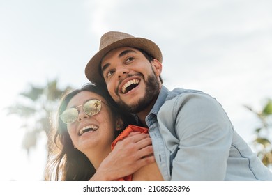 Close-up Of Two Happy Latino Friends Enjoying The Sun In The Street.