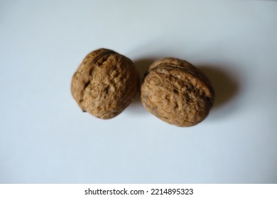 Closeup Of Two Ripe Brown Rounded Wrinkly Fruits Of Persian Walnut