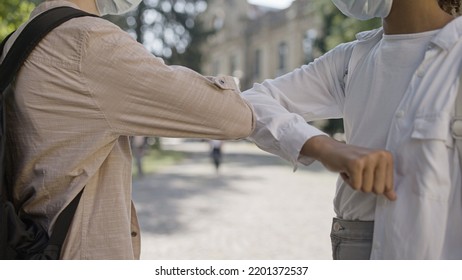 Close-up Of Two School Kids Wearing Face Masks Making Elbow Bump, Epidemic