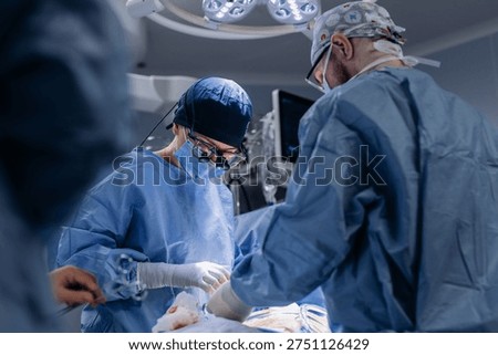 Close-up of two surgeons performing surgery in operating room. Concept of medical technologies and surgery.
