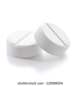 Close-up Of Two White Pills On White Background