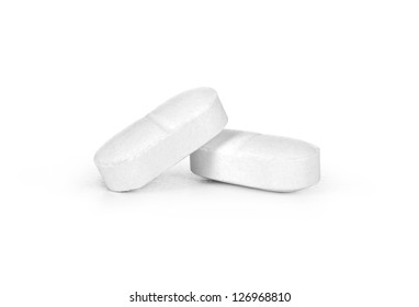 Close-up Of Two White Pills On White Background