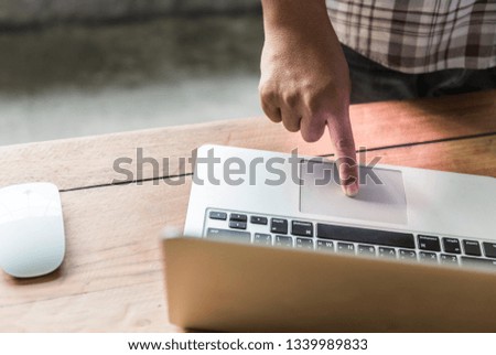 Close-up of typing  Businessman working laptop for new architectural project. Generic design notebook on the table. Blurred background.