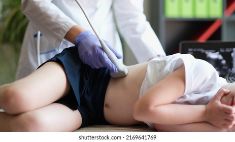 Close-up of ultrasound specialist examining little kid in clinic office. Ultrasound of liver and abdominal cavity procedure concept - Shutterstock ID 2169641769