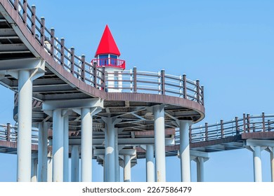 Closeup of underside of pedestrian pier with lighthouse replica for photo-ops. - Shutterstock ID 2267586479