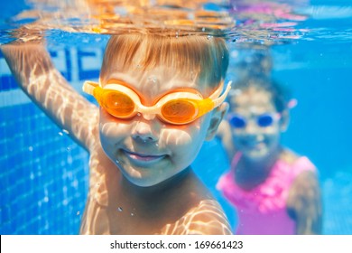 Close-up Underwater Portrait Of The Cute Smiling Boy