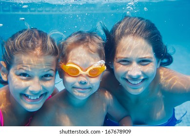 Close-up Underwater Portrait Of The Three Cute Smiling Kids