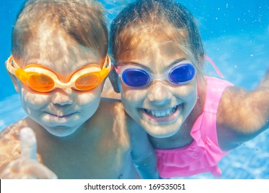 Close-up Underwater Portrait Of The Two Cute Smiling Kids