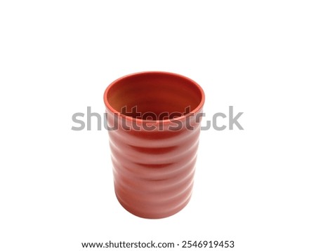 A close-up of a uniquely designed handleless glass, isolated on a clean white background, perfect for creative product showcases or minimalist desi