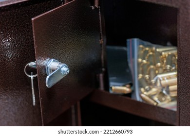 Closeup Of Unlocked Gun Safe Full Of Ammo In Plastic Bags, Focus In The Foreground 