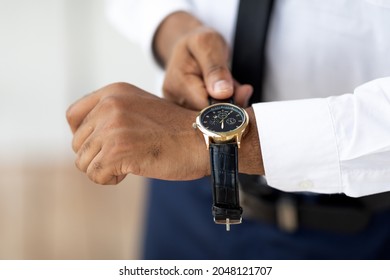 Closeup Of Unrecognizable African American Businessman Wearing Expensive Wrist Watch With Leather Strap Band, Stylish Male In Elegant Suit And White Shirt Getting Ready For Work In The Morning