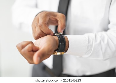 Closeup Of Unrecognizable African American Businessman Wearing Expensive Wrist Watch With Leather Strap Band, Stylish Male In Elegant White Shirt And Tie Getting Ready For Work In The Morning