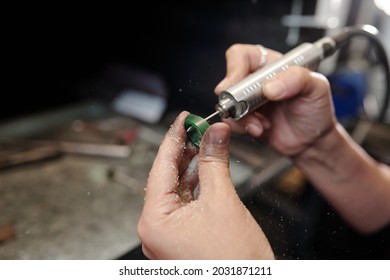 Close-up of unrecognizable female jeweler shaping ring using polishing tool in workshop - Shutterstock ID 2031871211