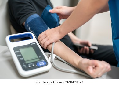 Closeup Of Unrecognizable Nurse Test Patient Blood Pressure.