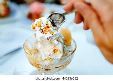 Close-up Of Unrecognizable Person Eating Delicious Ice Cream From Dessert Bowl